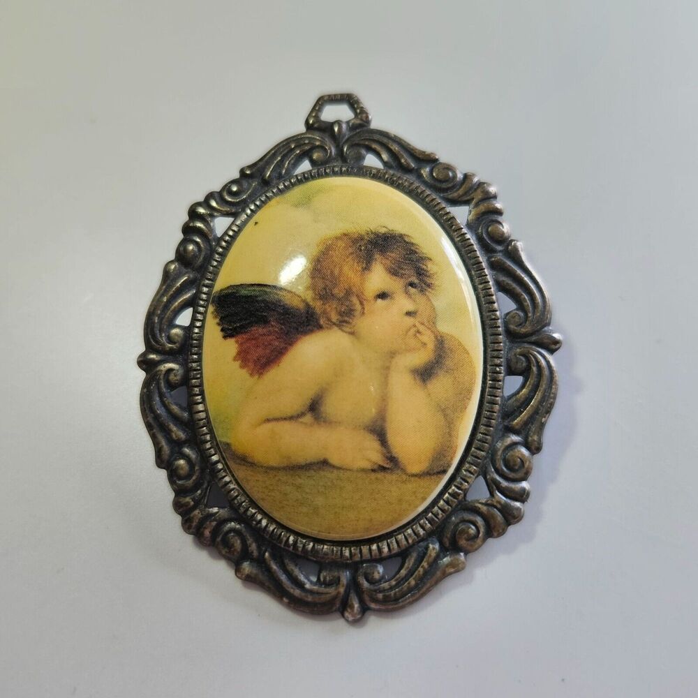 Silver tone vintage oval angel in thought brooch